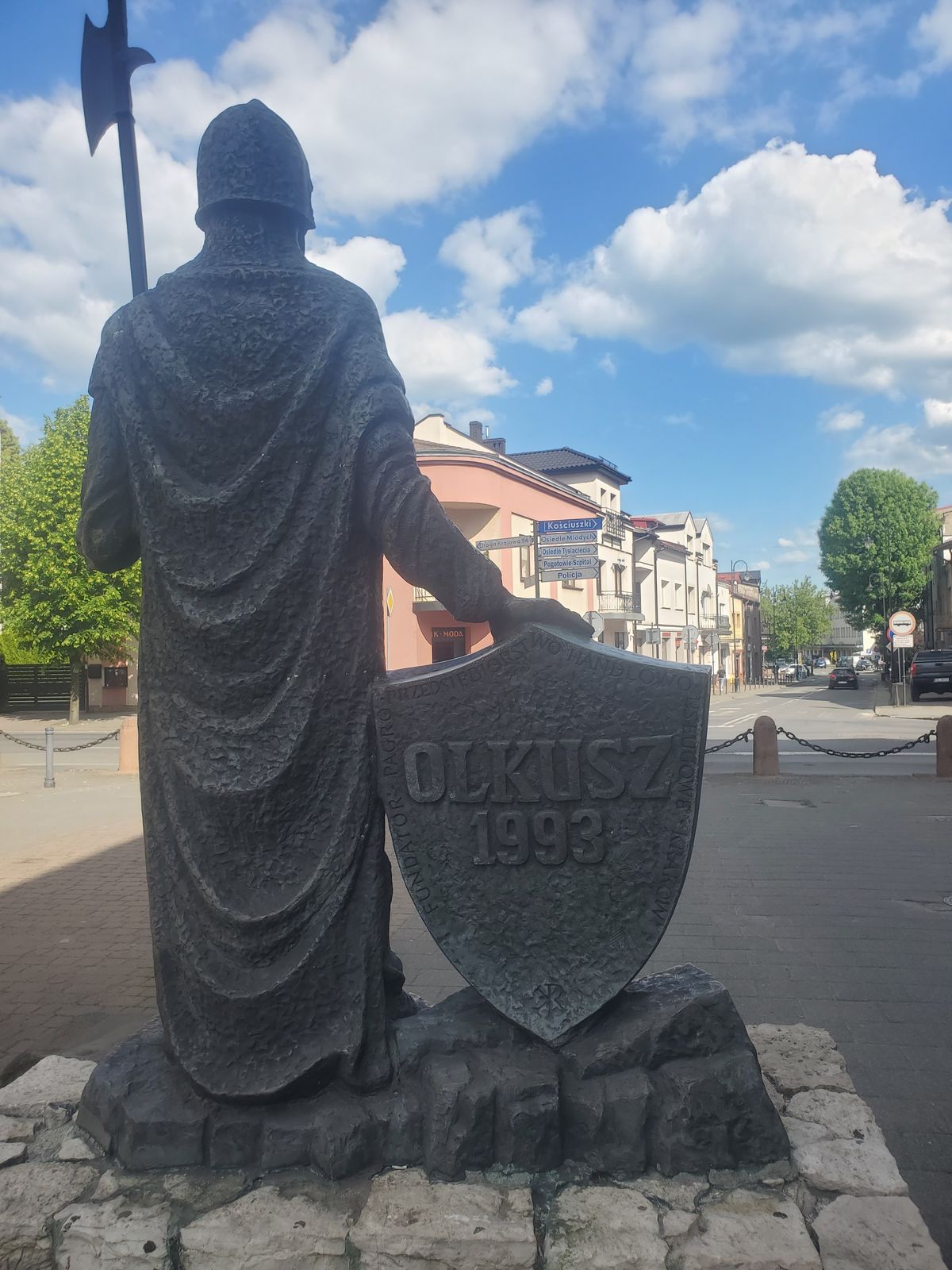 Olkusz town name embedded in a warrior's statue shield