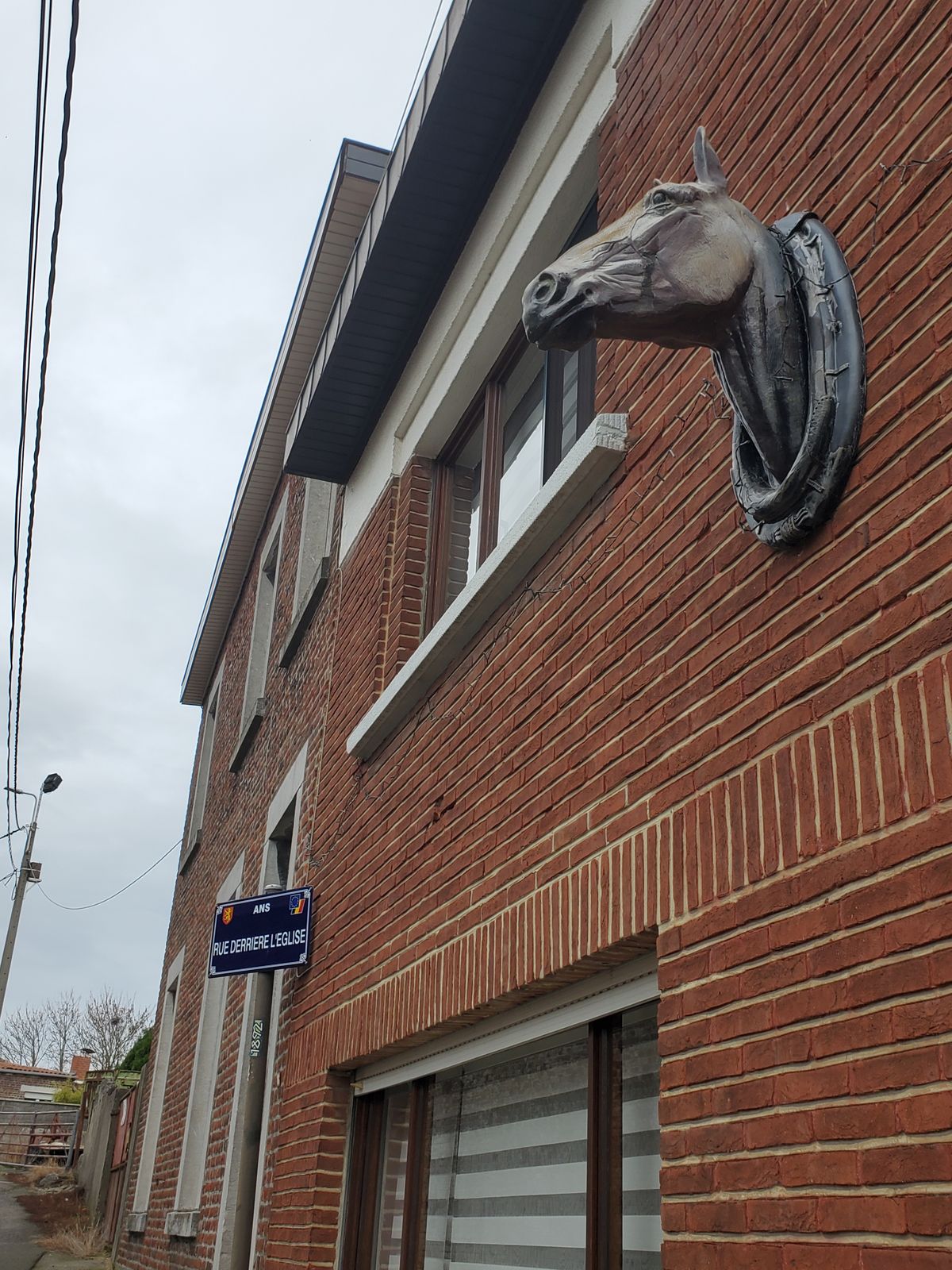 Decorative horse head on house's exterior wall