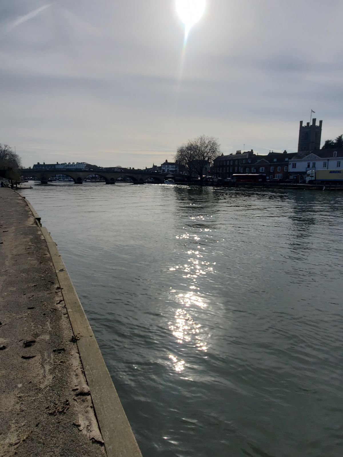 Henley on Thames bridge and town with shining sun in the skies